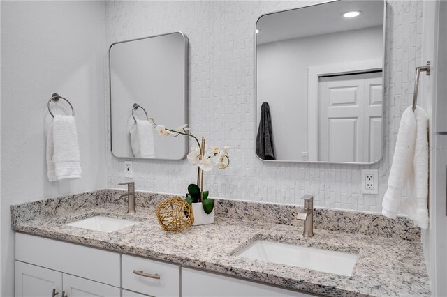 bathroom with vanity and tasteful backsplash