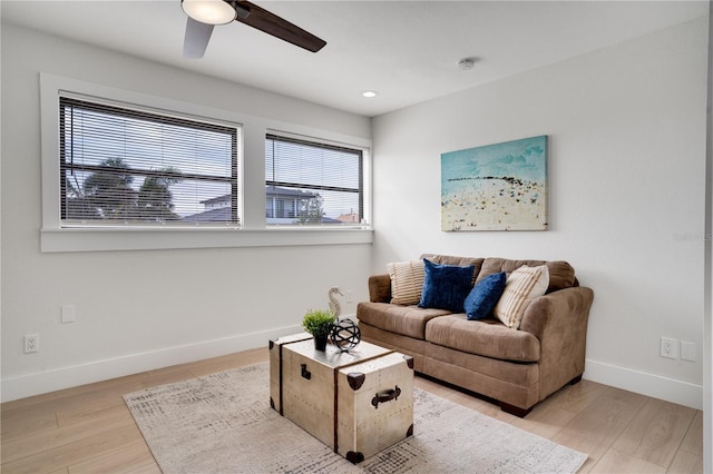 living room with light hardwood / wood-style floors and ceiling fan