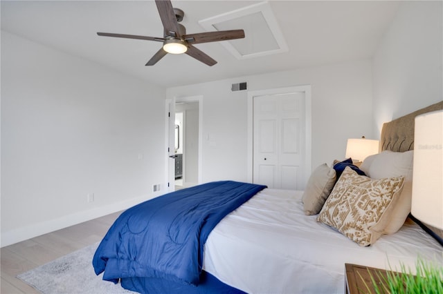 bedroom featuring a closet, hardwood / wood-style flooring, and ceiling fan