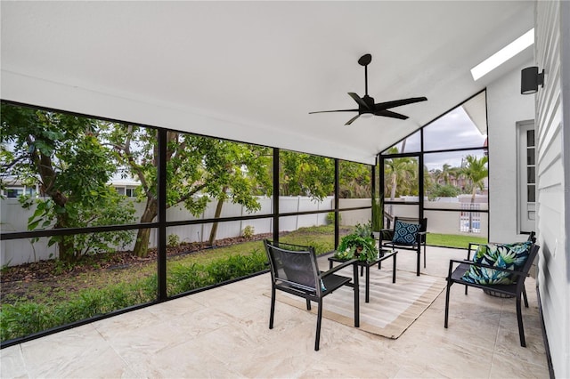 sunroom / solarium with ceiling fan and lofted ceiling with skylight