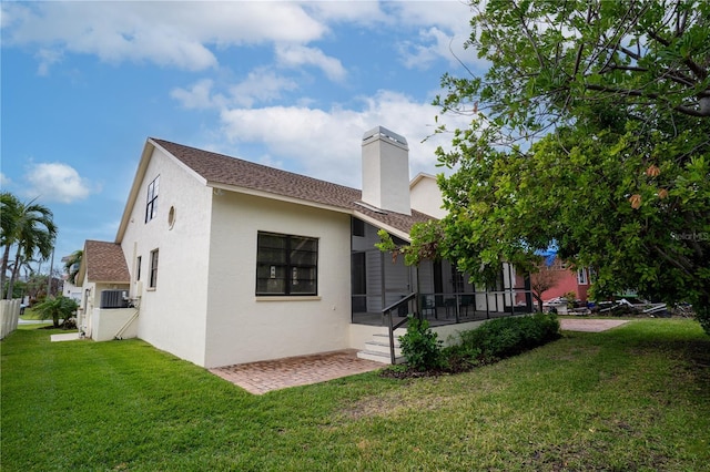 rear view of property with a lawn