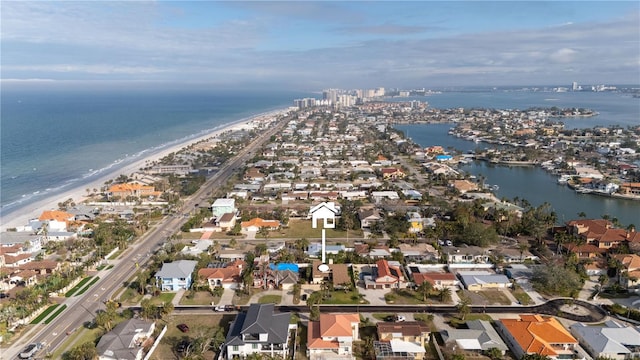 bird's eye view featuring a water view and a beach view