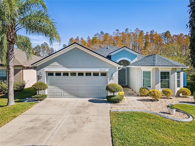 single story home with a garage and a front yard