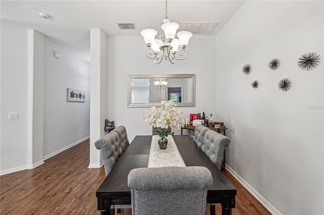 dining room featuring dark hardwood / wood-style flooring and an inviting chandelier