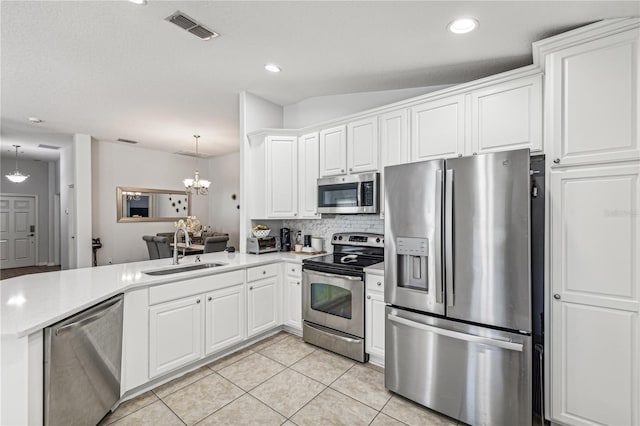 kitchen with light tile patterned floors, white cabinetry, sink, and appliances with stainless steel finishes