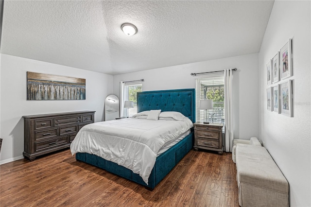 bedroom featuring a textured ceiling and dark wood-type flooring