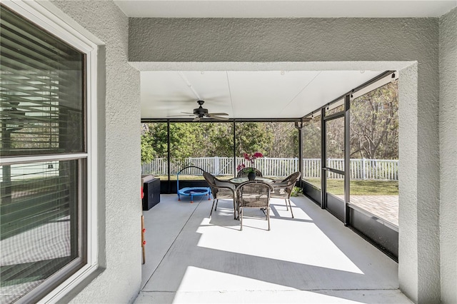 sunroom / solarium featuring ceiling fan and a healthy amount of sunlight