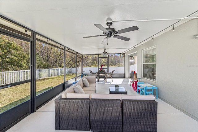 sunroom featuring ceiling fan and a healthy amount of sunlight