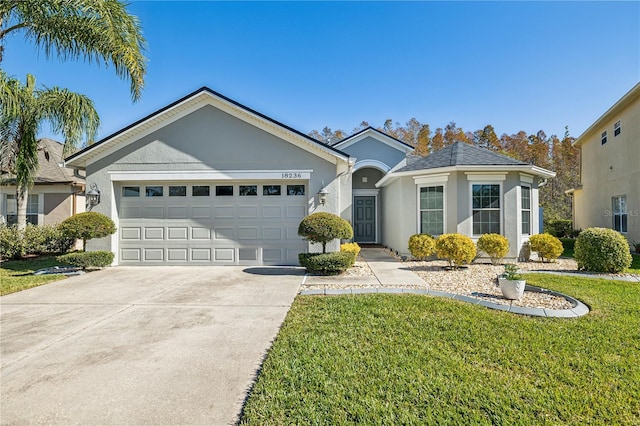 ranch-style house with a garage and a front lawn