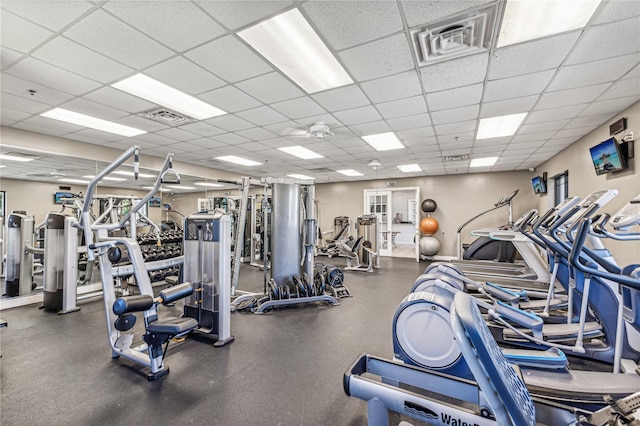 gym with a paneled ceiling