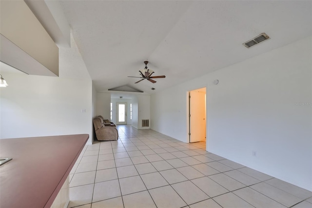 tiled spare room featuring ceiling fan and vaulted ceiling