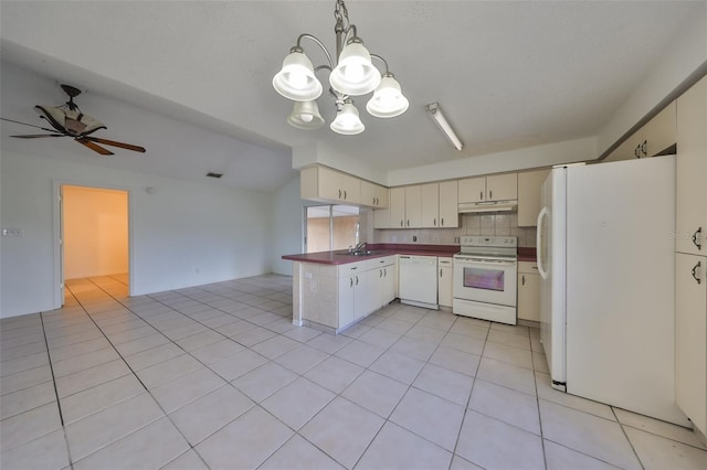 kitchen with backsplash, ceiling fan with notable chandelier, white appliances, pendant lighting, and cream cabinets