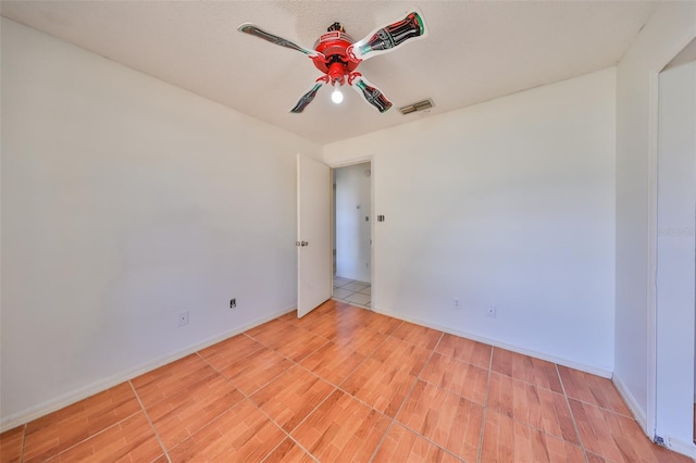 empty room featuring hardwood / wood-style floors and ceiling fan