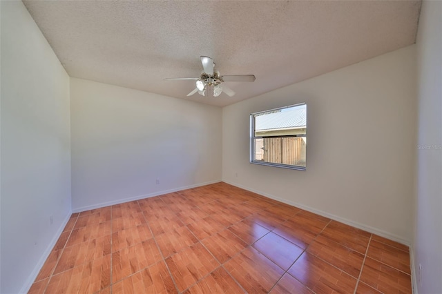 empty room with a textured ceiling, light wood-type flooring, and ceiling fan