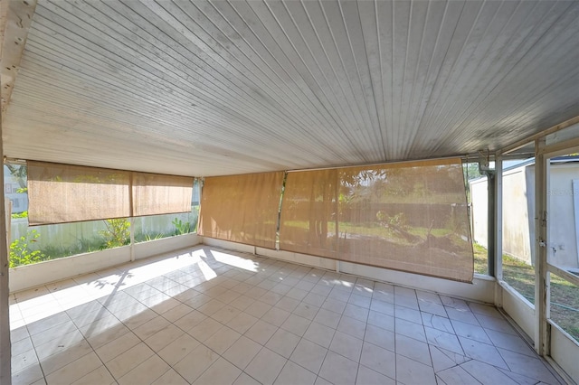 unfurnished sunroom featuring wood ceiling