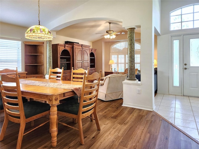 dining room with decorative columns, ceiling fan, a healthy amount of sunlight, and hardwood / wood-style flooring