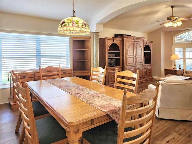 dining area featuring dark hardwood / wood-style flooring, decorative columns, vaulted ceiling, and ceiling fan