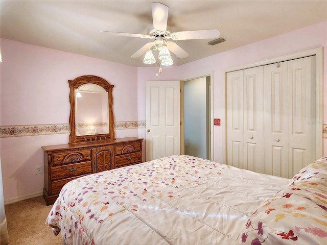 bedroom with light carpet, a closet, and ceiling fan