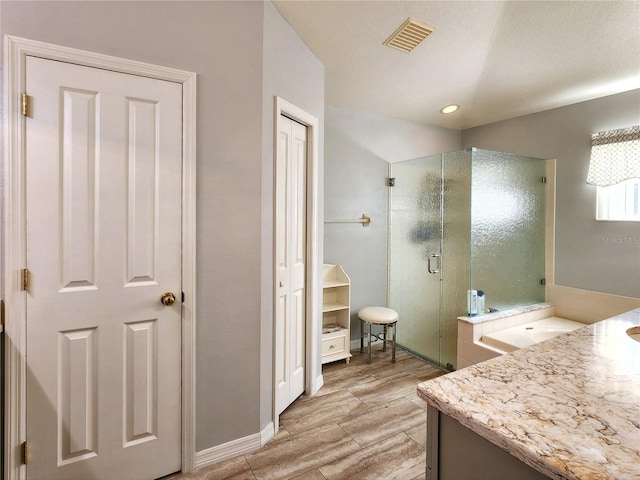 bathroom featuring vanity and an enclosed shower