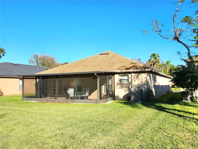 back of house featuring a yard, central AC, and a sunroom