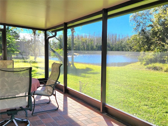 unfurnished sunroom with a water view