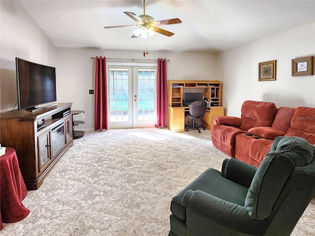 carpeted living room with ceiling fan and french doors