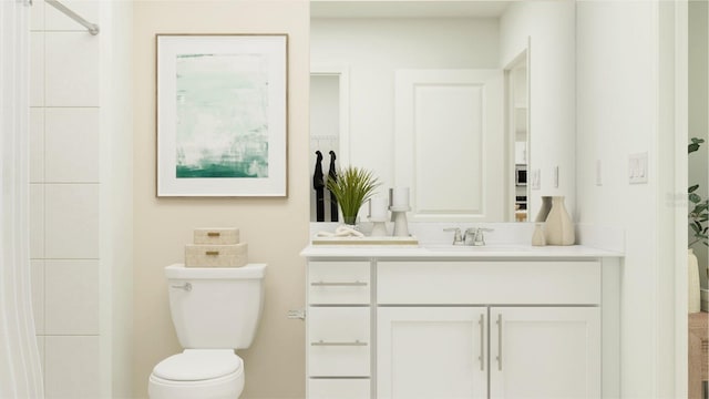 bathroom with a shower, vanity, and toilet