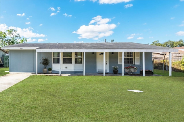 ranch-style house featuring covered porch, a front lawn, and a carport