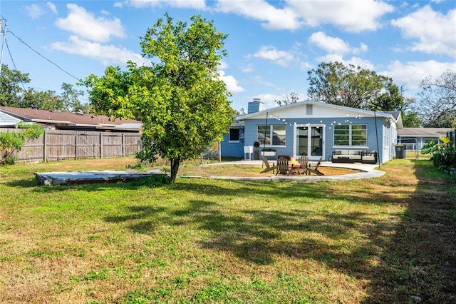 back of property featuring a yard and a patio