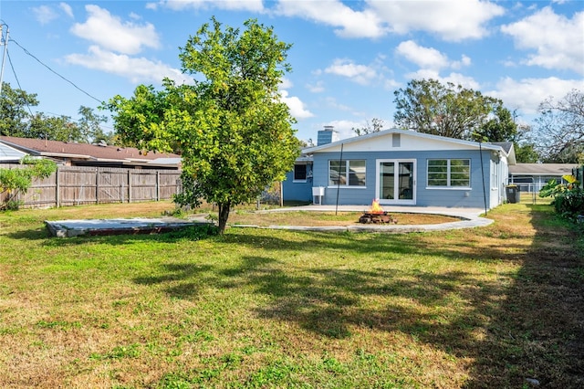 back of property featuring a patio area and a yard