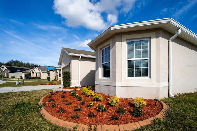 view of side of home with a lawn