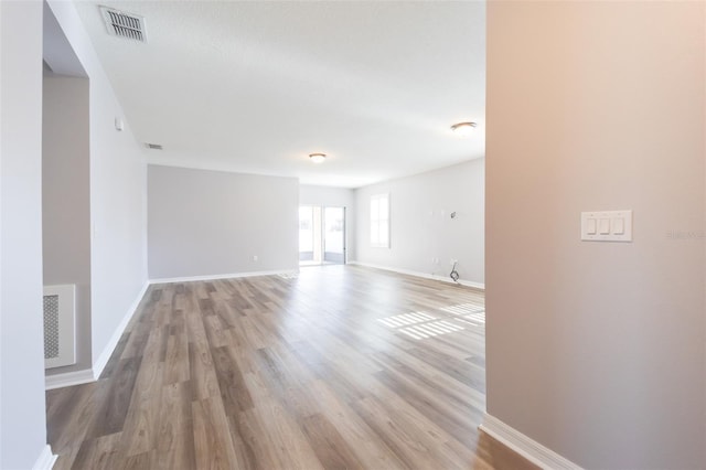 spare room with hardwood / wood-style flooring