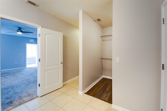 interior space featuring light tile patterned flooring and a textured ceiling