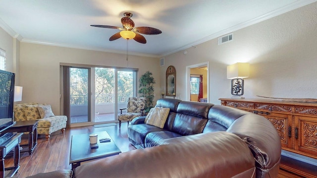 living room featuring ceiling fan, dark hardwood / wood-style flooring, and ornamental molding