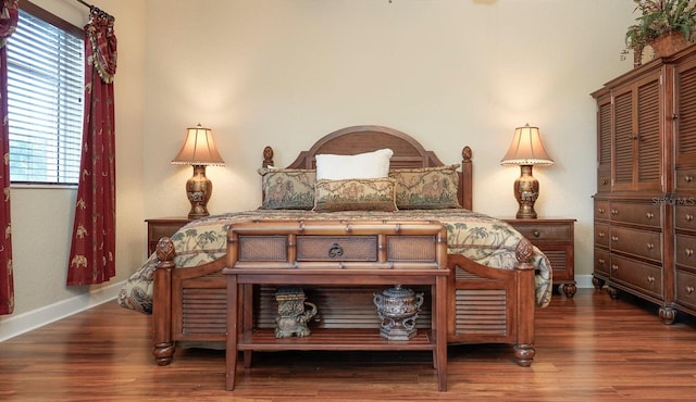 bedroom with dark wood-type flooring