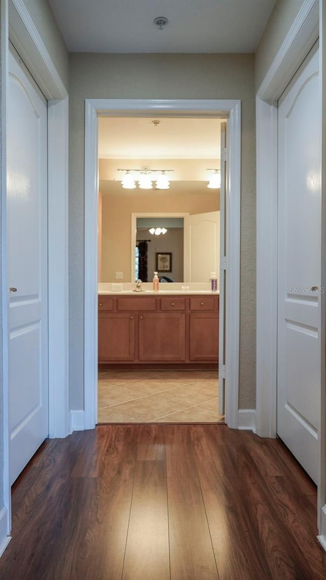 hallway featuring sink and dark hardwood / wood-style floors