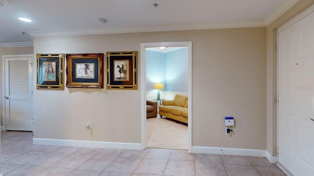 interior space featuring light tile patterned floors and ornamental molding