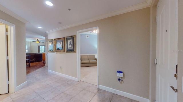 hall with light tile patterned floors and ornamental molding