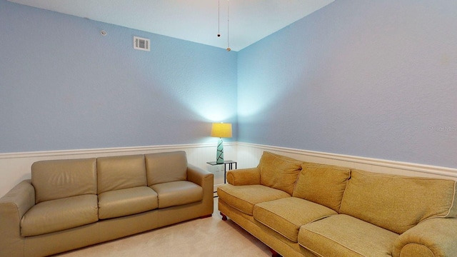 carpeted living room with lofted ceiling