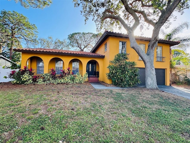 mediterranean / spanish-style house with a garage