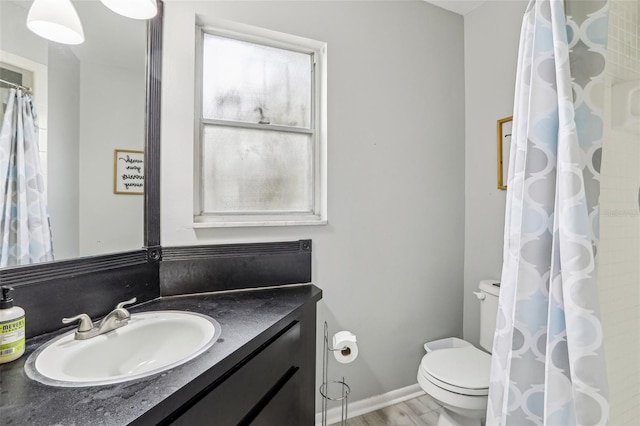 bathroom with vanity, hardwood / wood-style floors, a shower with shower curtain, and toilet