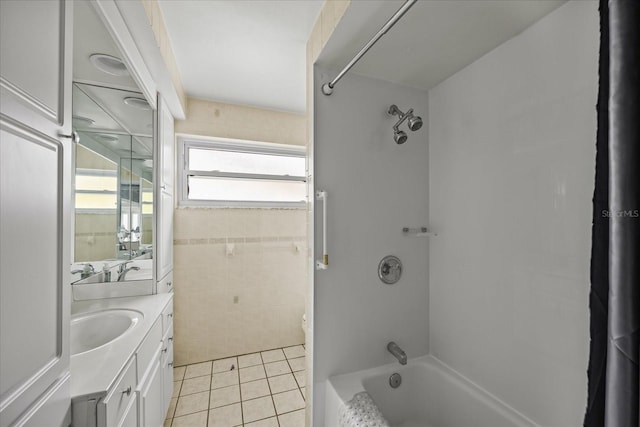 bathroom with tile patterned floors, vanity, and washtub / shower combination