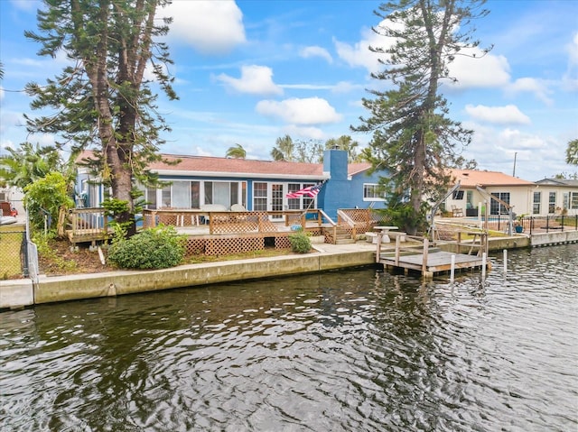 back of property with a deck with water view