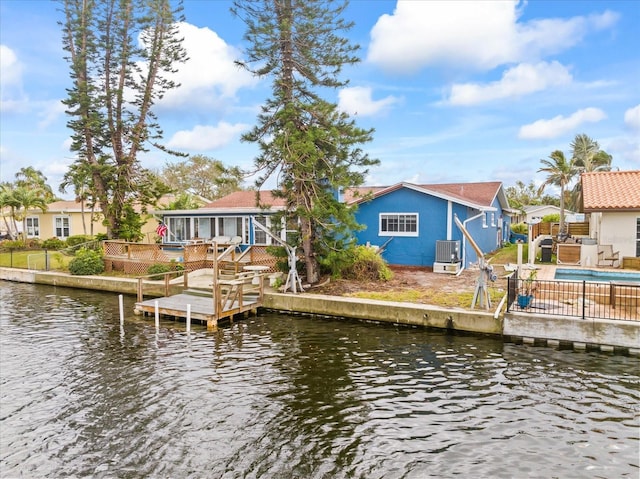 dock area featuring a deck with water view and central AC unit