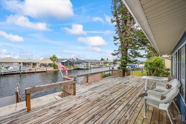 deck with a boat dock and a water view