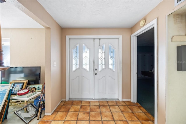 foyer entrance with a textured ceiling