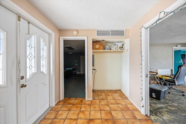 foyer with a textured ceiling