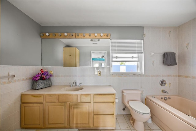 bathroom featuring tile patterned flooring, vanity, tile walls, and toilet