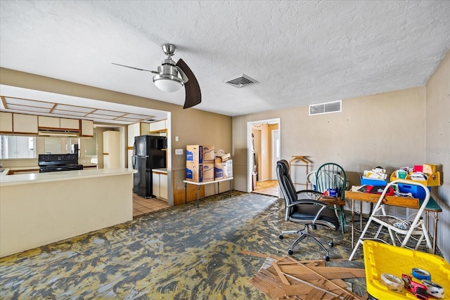 interior space featuring ceiling fan and a textured ceiling