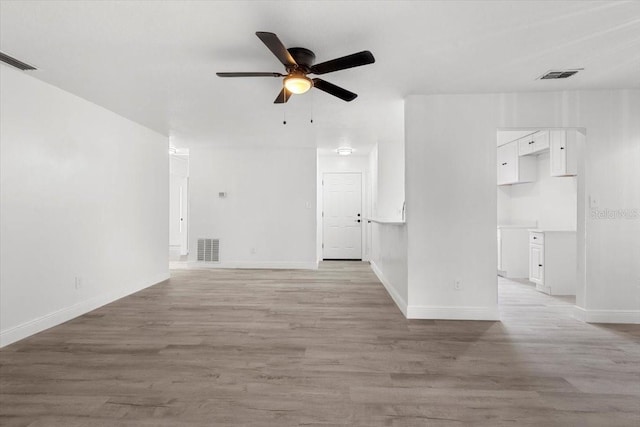 unfurnished living room featuring ceiling fan and light wood-type flooring